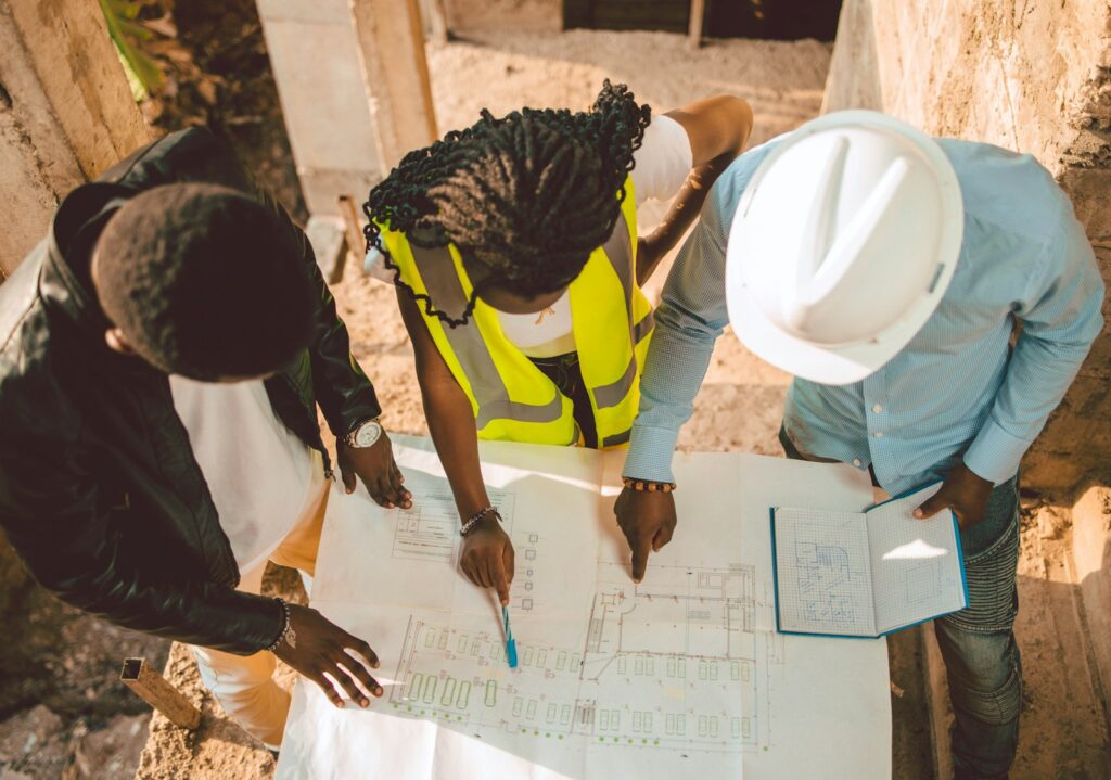 a group of people writing on a piece of paper